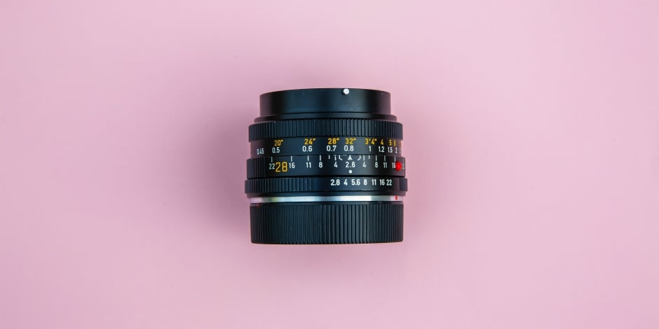 Camera lens on a pink background