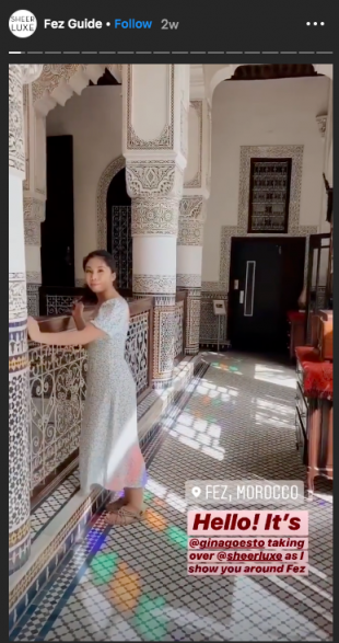 Instagram Story from Sheer Luxe, influencer stands in a Mosque. Text: "Hello! It's @ginagoesto taking over @sheerluxe as I show you around Fez"